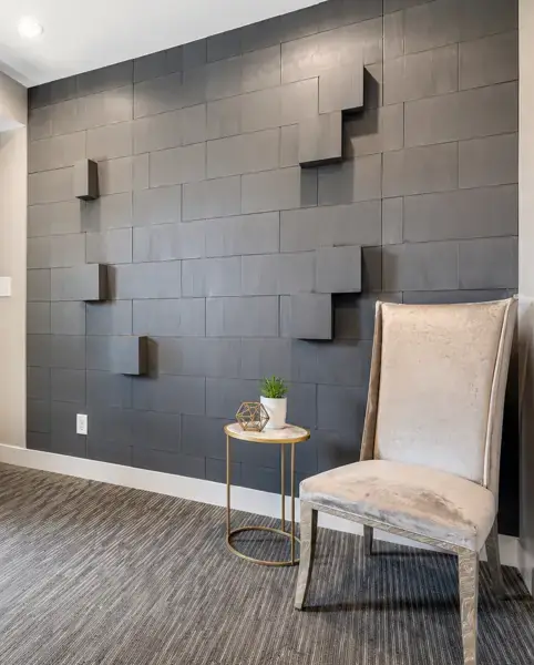 Lounge corner with a velvet chair against a textured wall